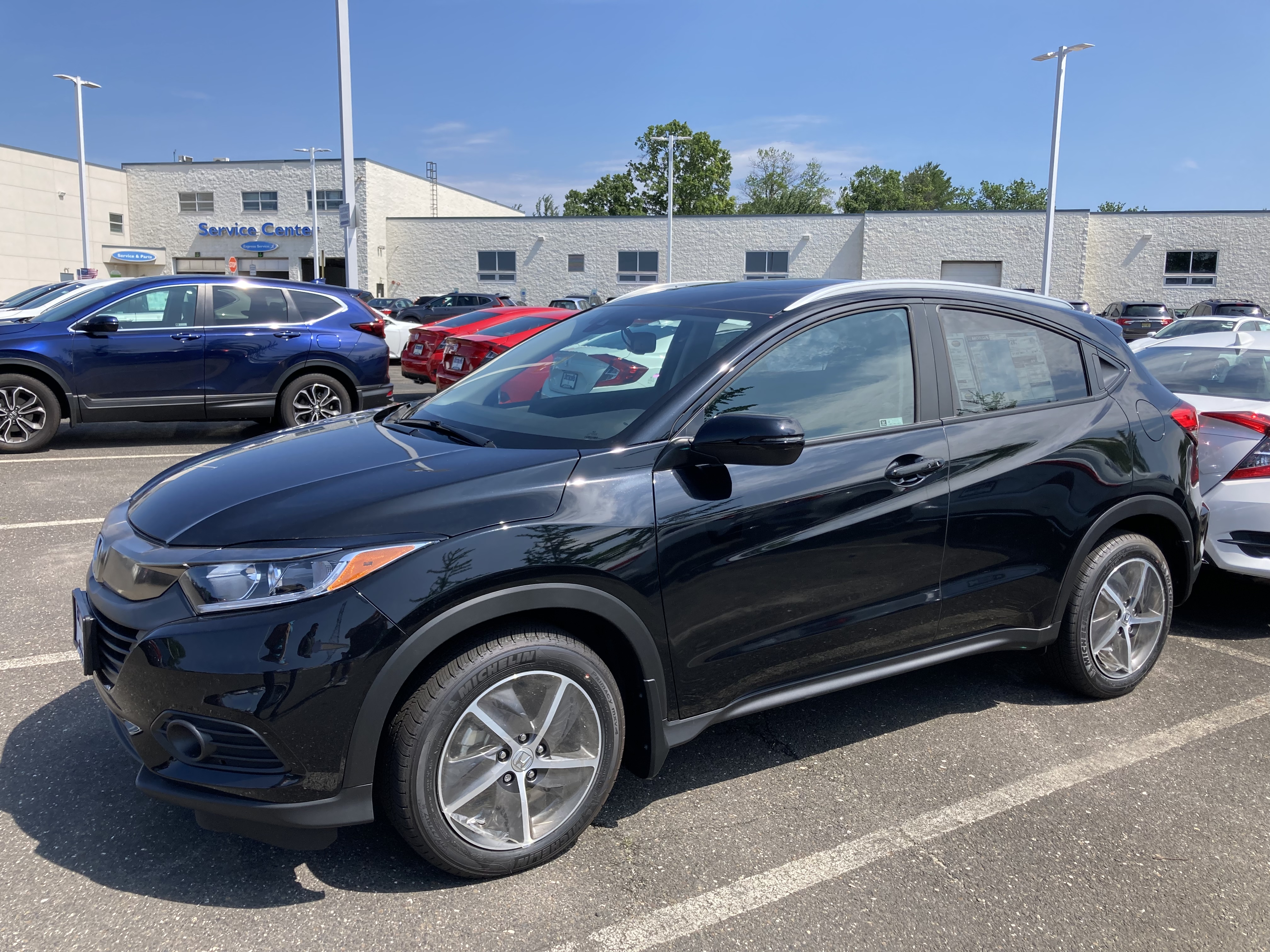 Black Honda HR-V on dealership lot.