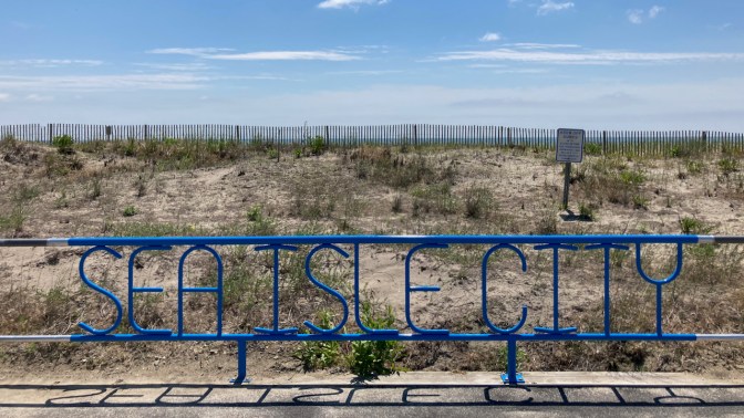 Steel fence with words SEA ISLE CITY in metalwork.