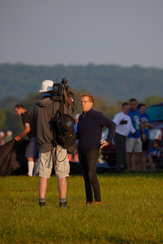 TV personality John Elliott in front of cameraman.