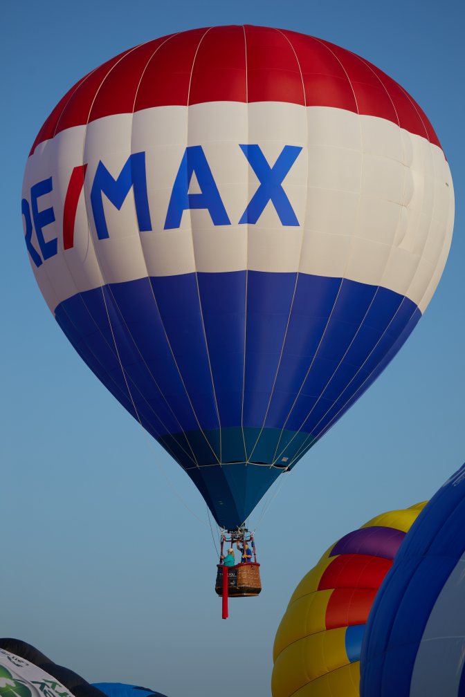 Large blue-and-white RE/MAX balloon.