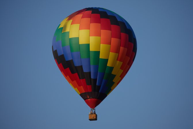 Multicolored balloon in sky.