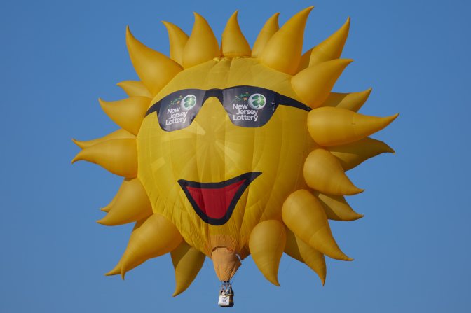 Hot air balloon of the sun, wearing sunglasses.