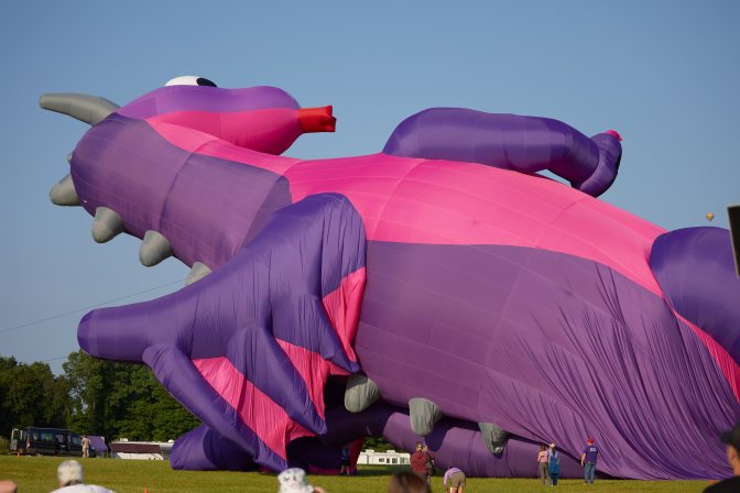 Large dragon balloon on ground.