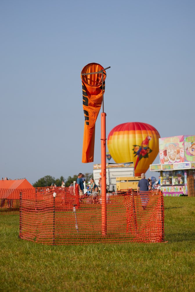 Wind sock hanging loosely on pole.