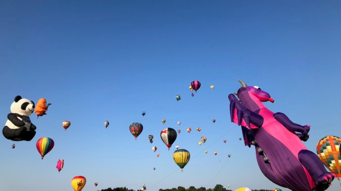 Balloons in flight in air.