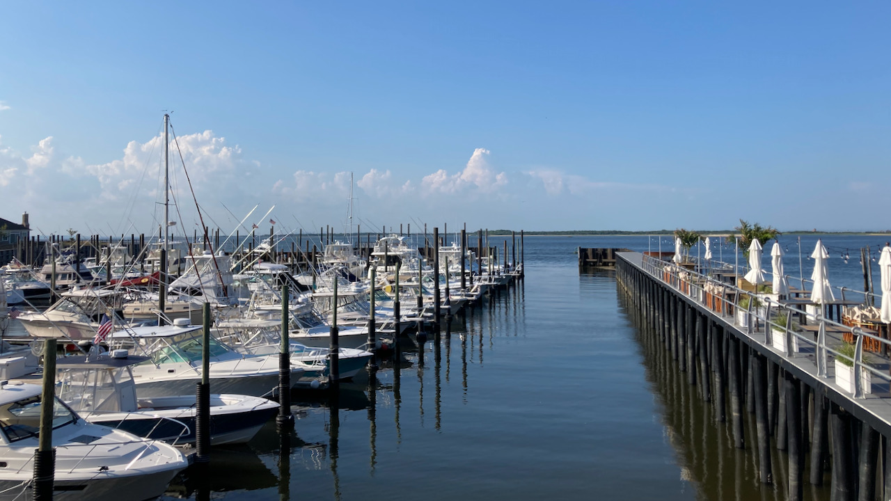 View of harbor and dock-side seating at restaurant seating.