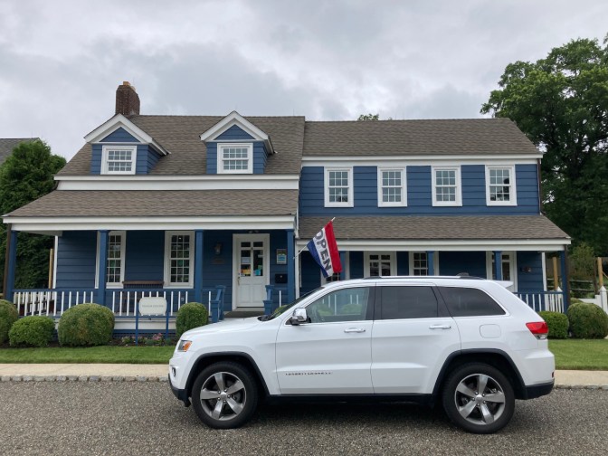 White Jeep Grand Cherokee parked in front of the Blue House.