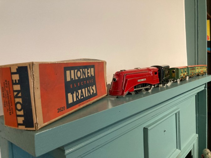 Lionel toy trains on mantelpiece.