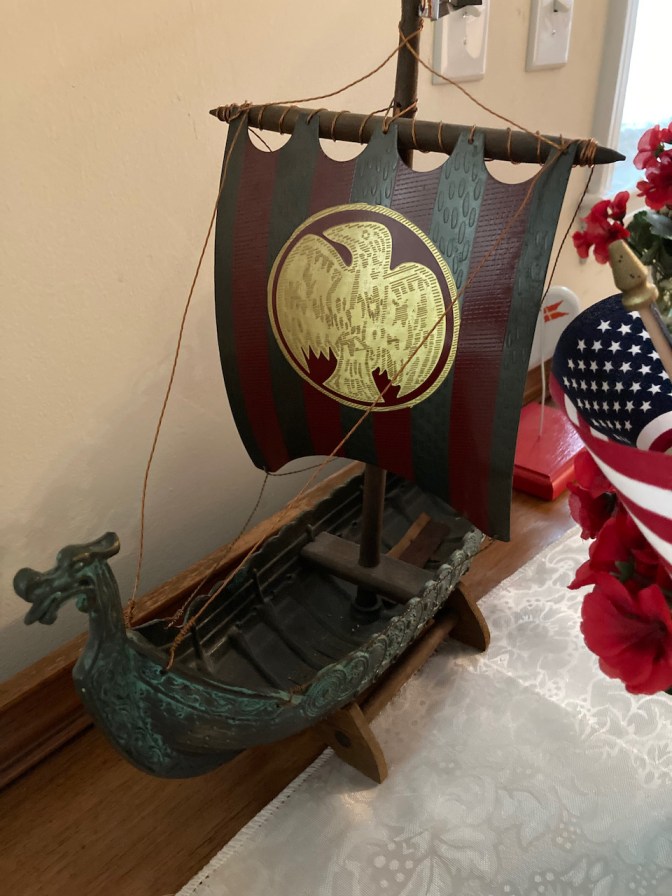Model of Viking ship on desk.
