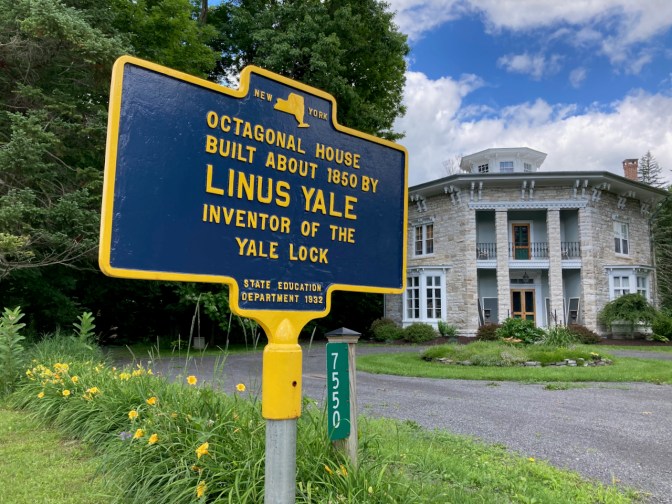 Octagonal House ,with sign in foreground that says OCTAGONAL HOUSE BUILT ABOUT 1850 BY LINUS YALE INVENTOR OF THE YALE LOCK.