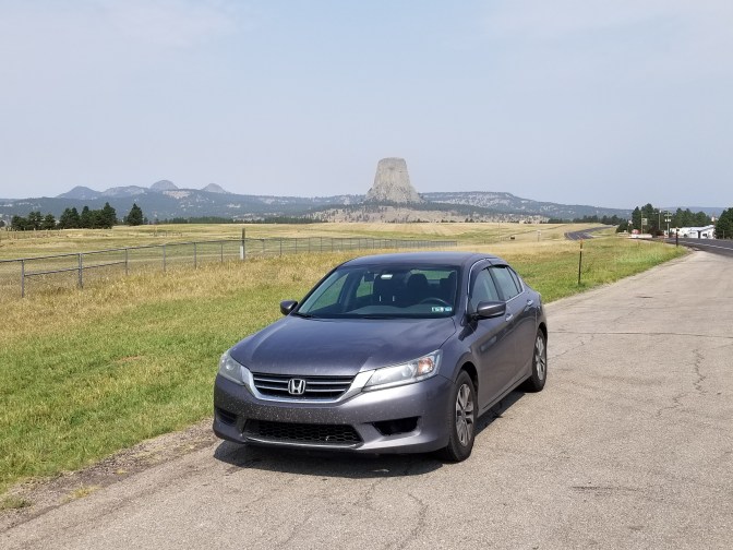 2015 Honda Accord sedan parked in front of Devil's Tower.