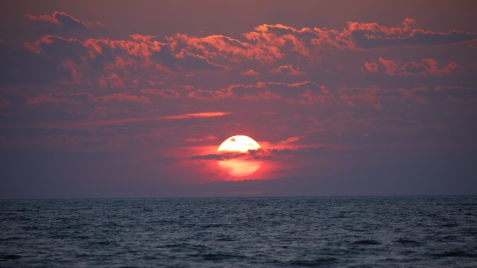 Red sky and sunset over ocean.