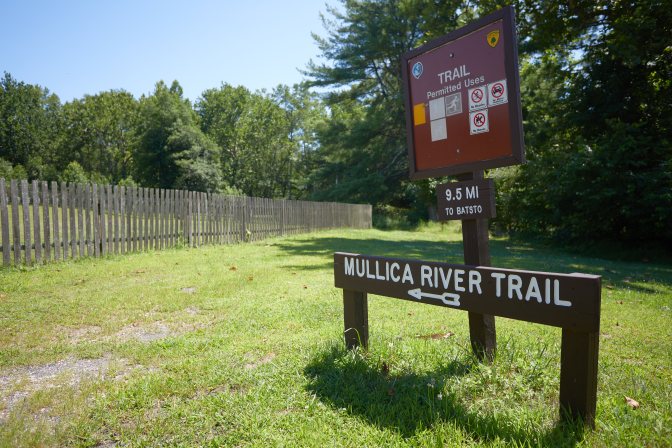 Sign that says MULLICA RIVER TRAIL, with arrow pointing toward trail.