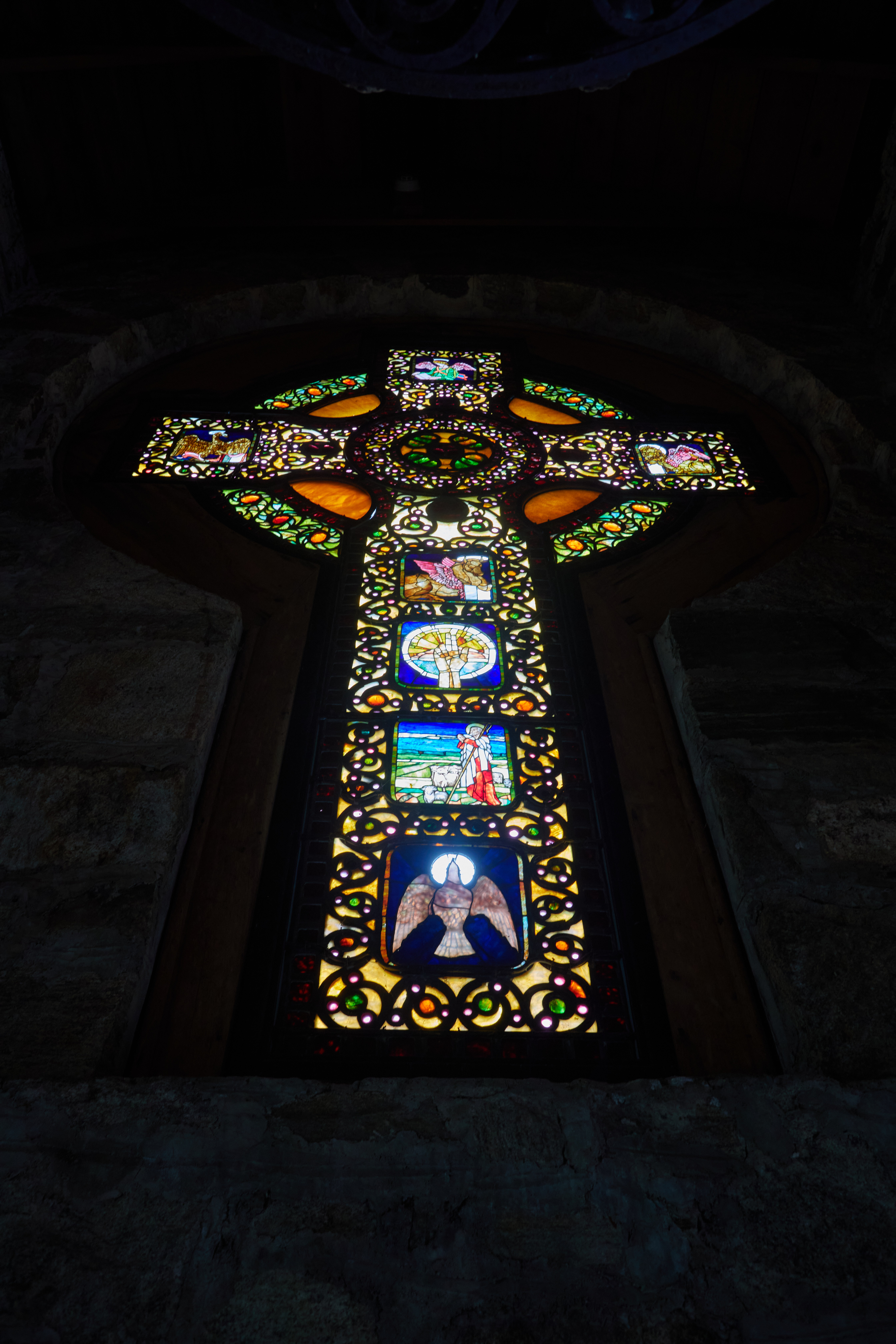 Stained glass window in shape of cross.