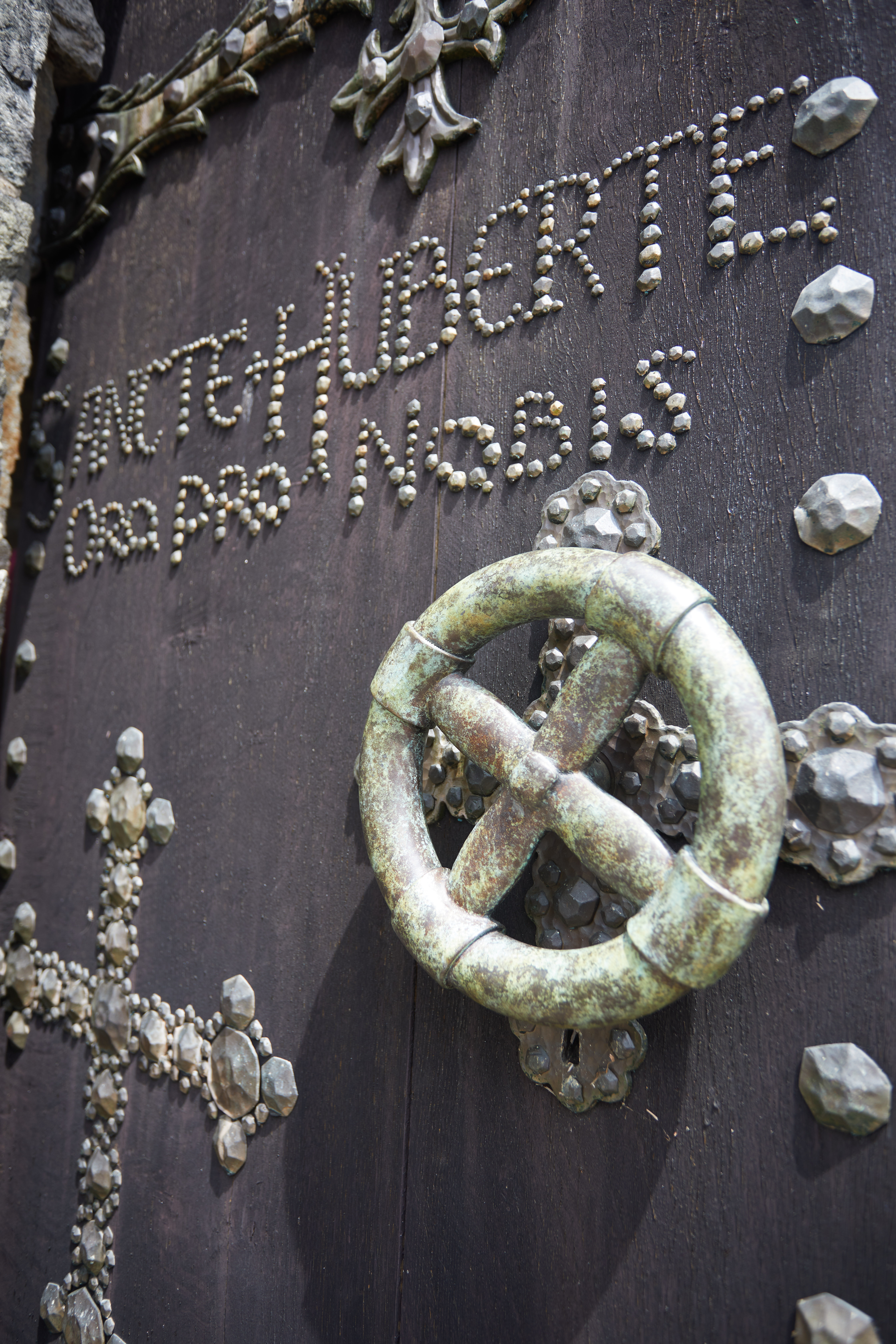 Front door, with words SANCTE HUBERTE ORO PRO NOBIS in stone.