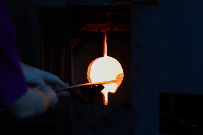 Blowpipe and glass ornament, inserted into oven.
