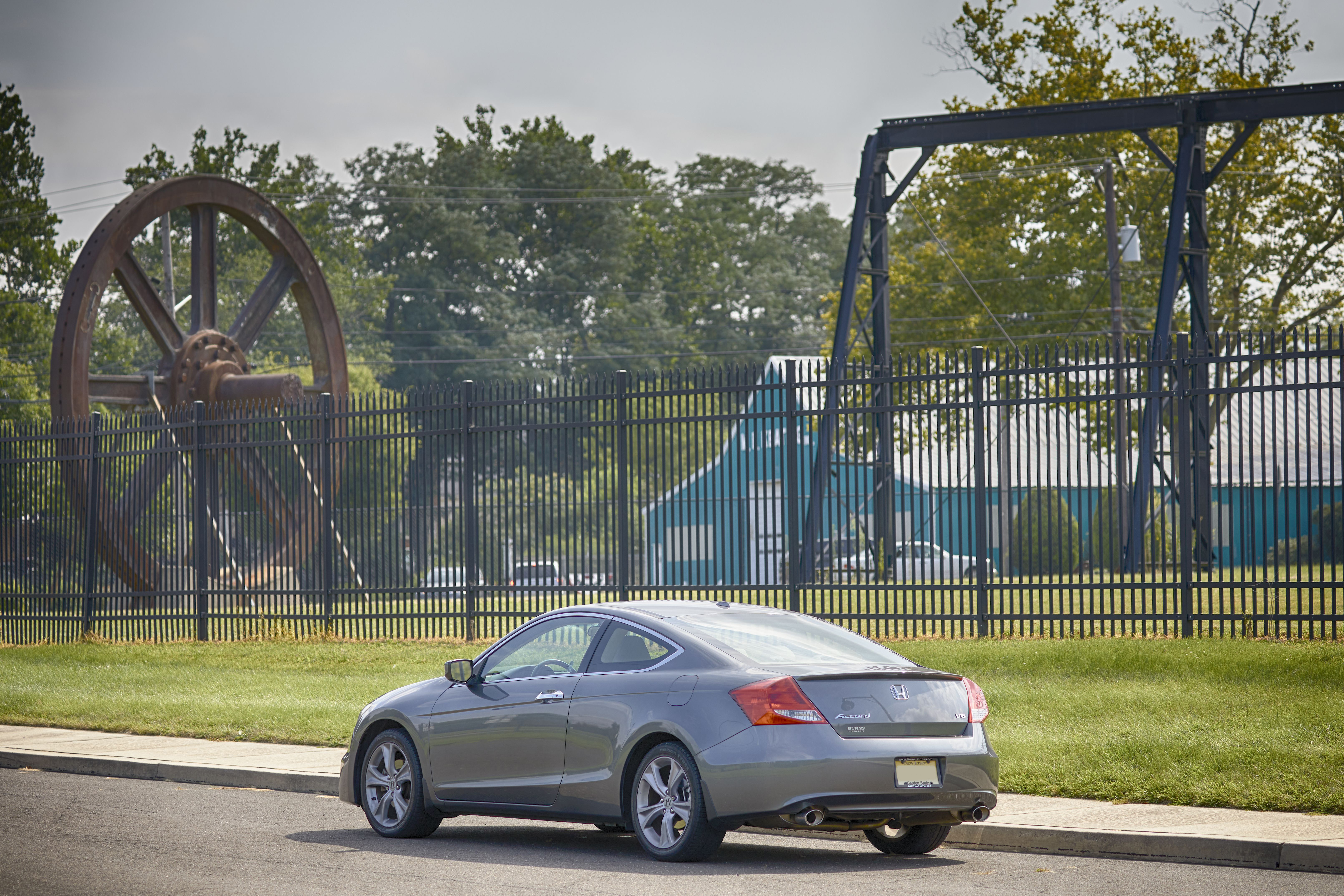 2012 Honda Accord parked outside of gates for Roebling Museum. Large equipment is in the background.