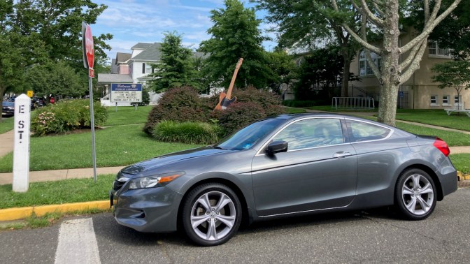 2012 Honda Accord coupe parked in front of statue of Fender Esquire guitar.
