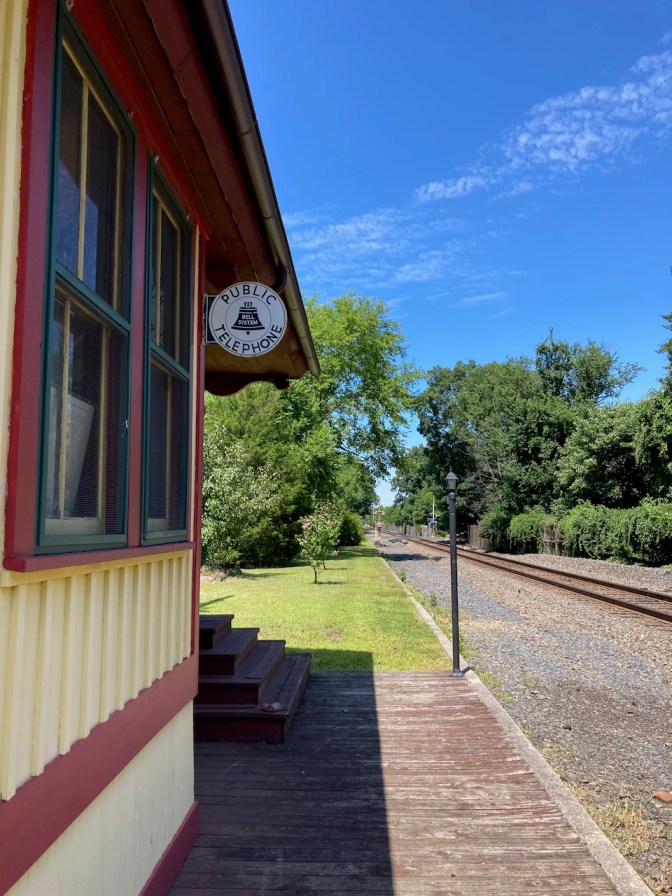 Sign for Public Telephone on side of station.