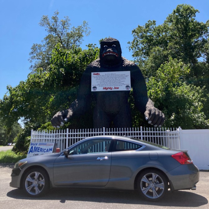2012 Honda Accord coupe parked in front of gorilla statue.