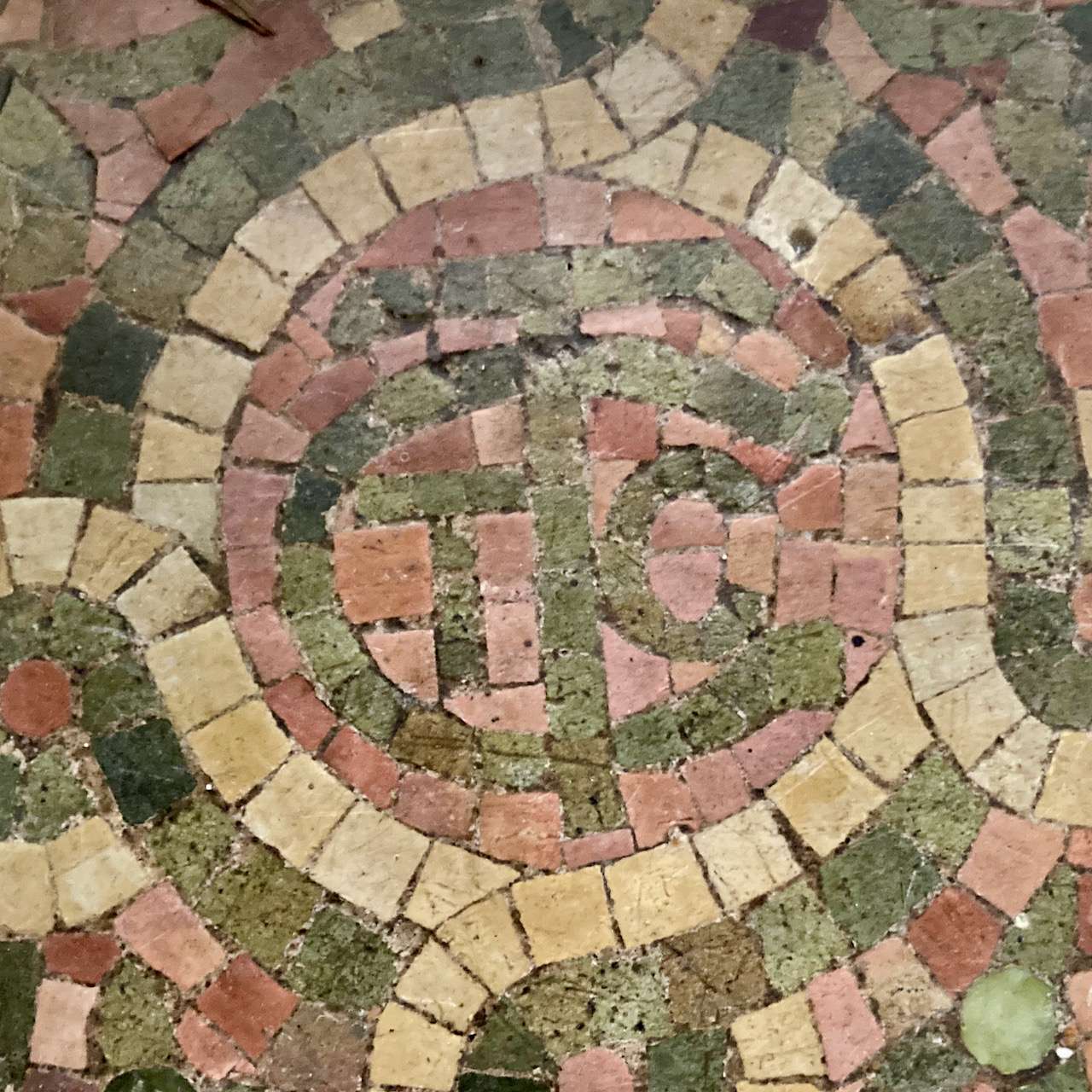 Initials LCT in stone mosaic on floor.