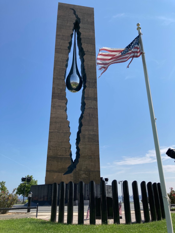 Teardrop Memorial with American flag in foreground.