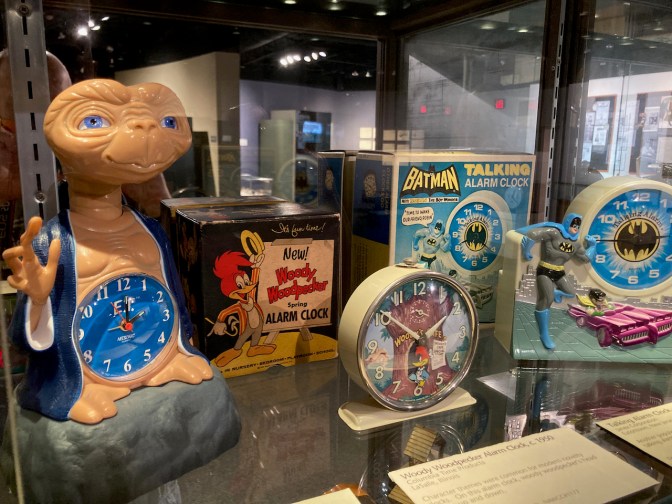 Collection of toy clocks, including ET, Woody Woodpecker, and Batman.