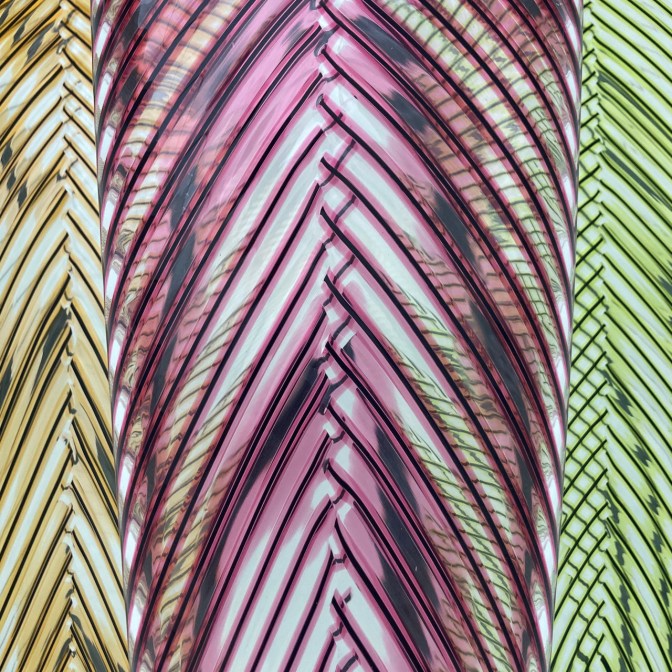Closeup of glasswork of a vase in multicolored glass.