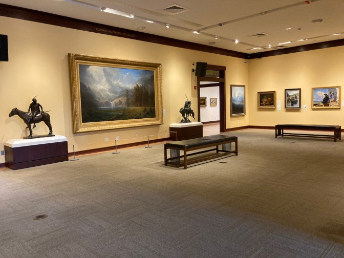 Gallery of American art with paintings hung around room.