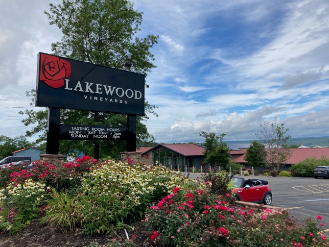 Large sign for Lakewood Vineyards and winery is in background.