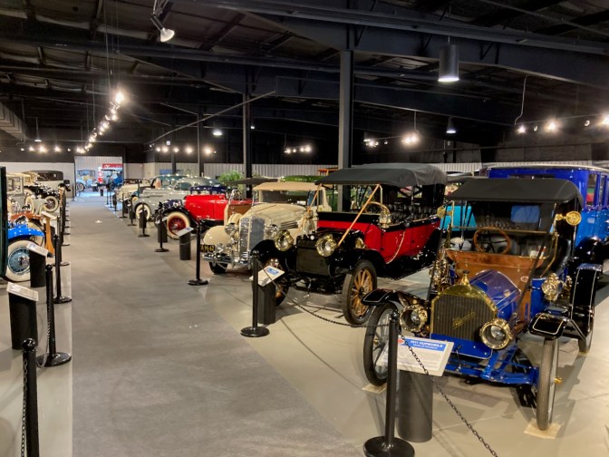 Rows of classic cars in museum.