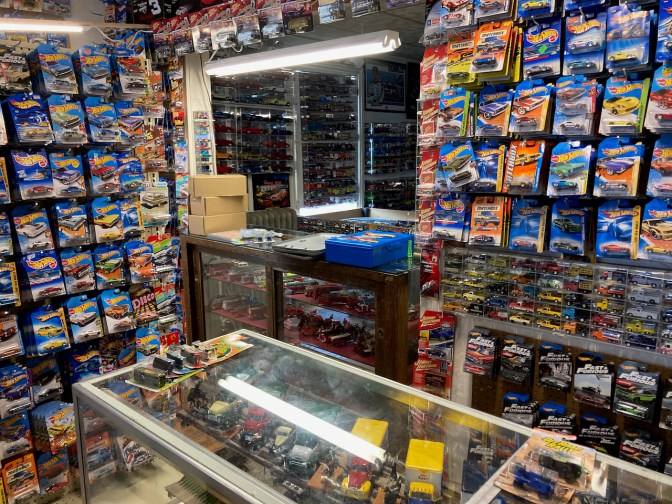 Front counter, with walls filled with die cast toy cars.