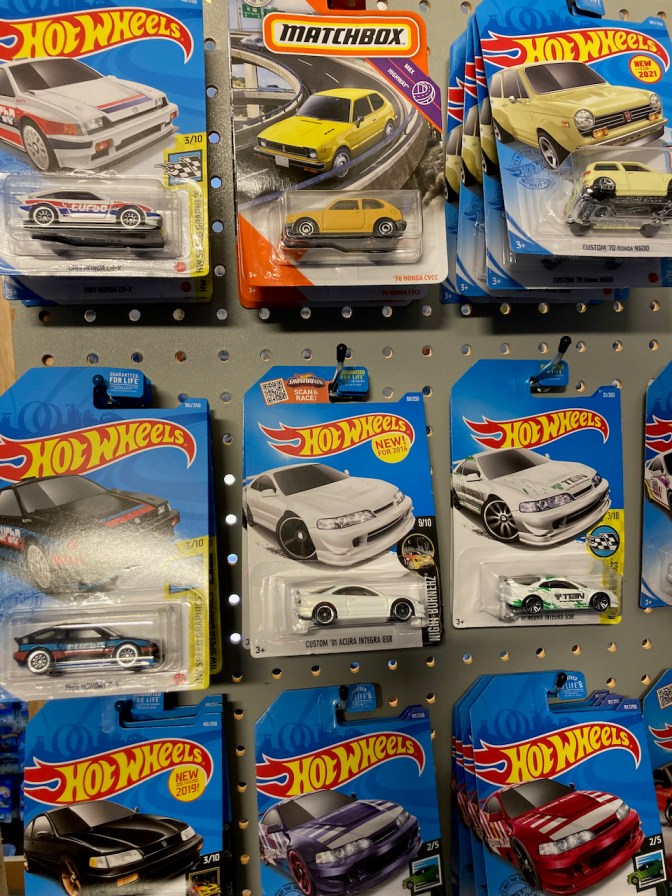 Honda and Acura toy cars in Hotwheels and Matchbox packaging.