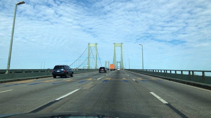 View of Delaware Memorial Bridge, with NEW JERSEY and DELAWARE written on bridge road surface.