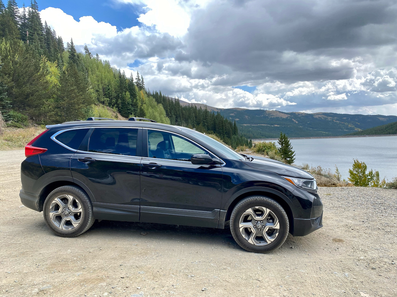 2017 Honda CR-V parked in front of lake and mountains.