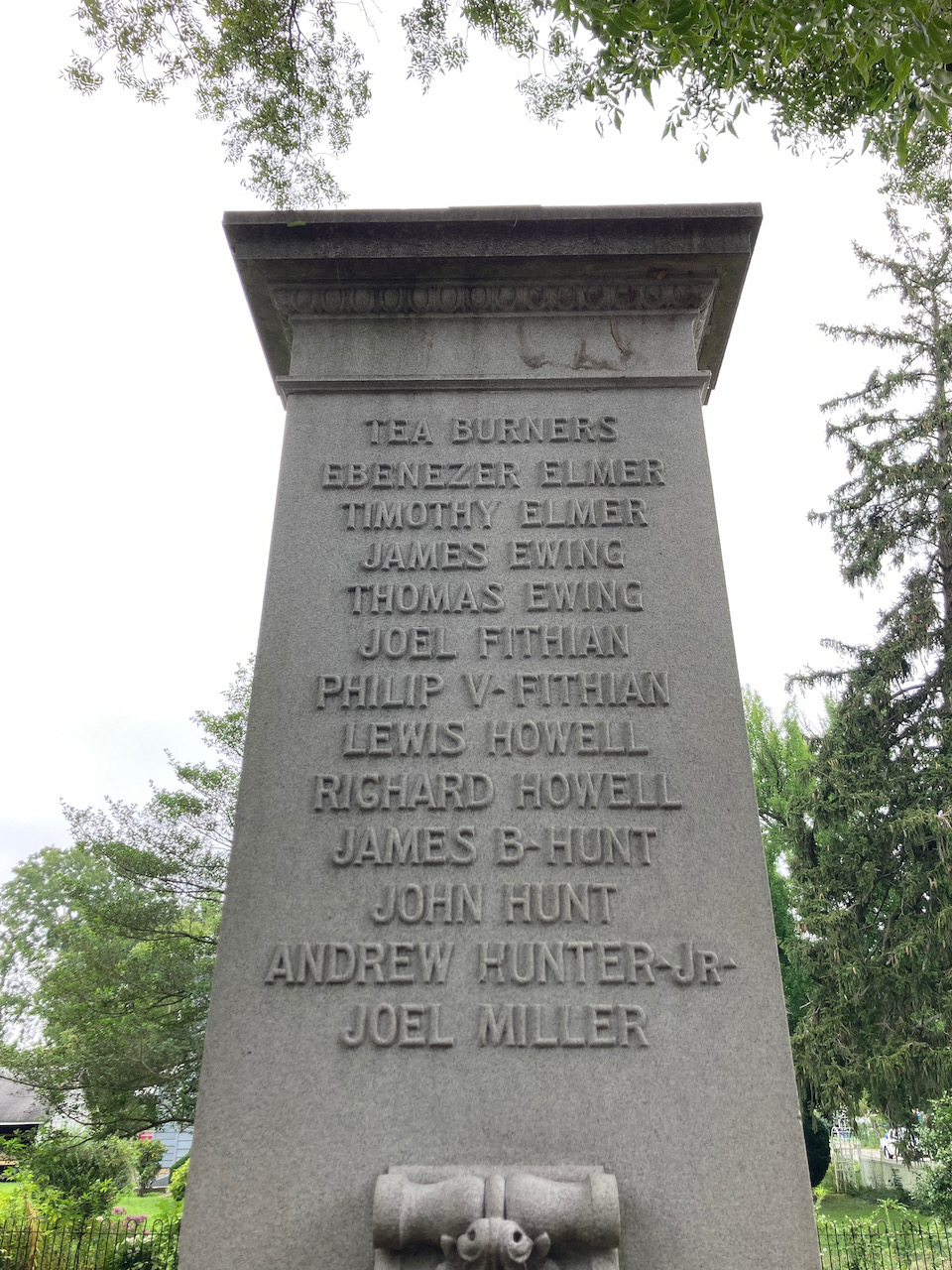 Monument with names of "Tea Burners" inscribed on side.