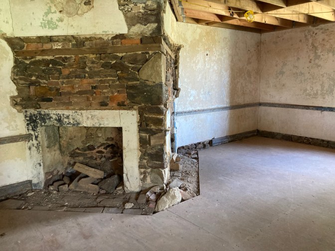 Interior of stone house, with original fireplace.