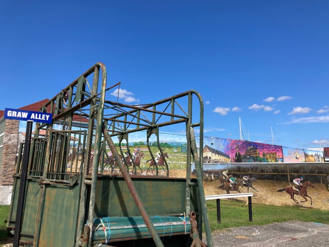 Starting gate, and murals of racetrack.