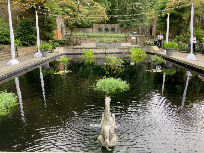 Reflecting pool, surrounded by trees.