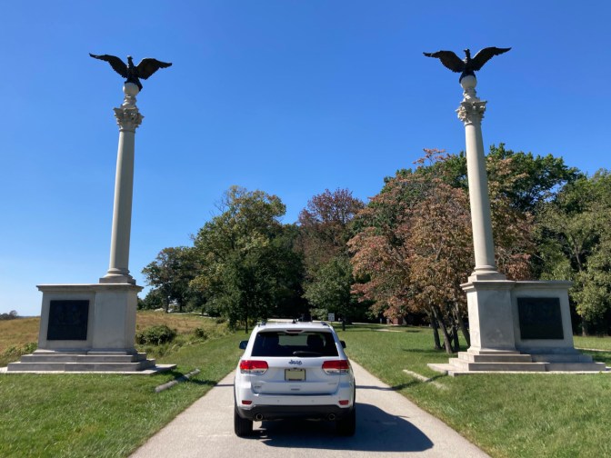 2014 Jeep Grand Cherokee parked between Pennsylvania Columns. 