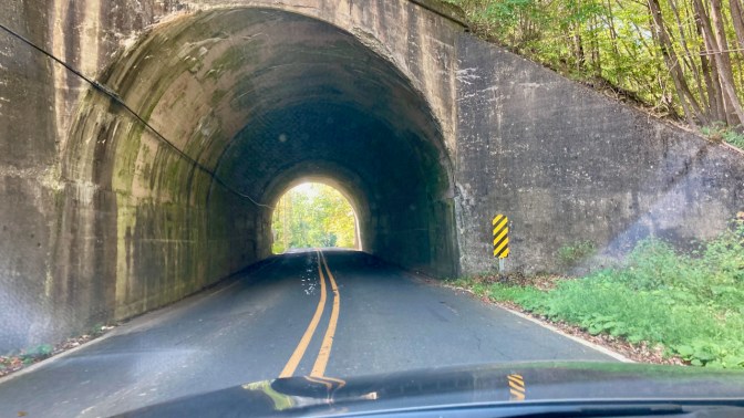 Narrow tunnel beneath hillside. 