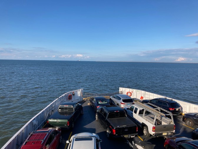 View of bow of ferry, with vehicles on deck. 