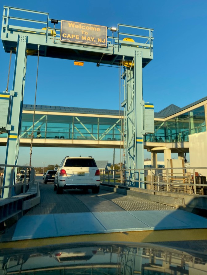 View of entry bridge from boat to terminal, with sign overhead that says WELCOME TO CAPE MAY NJ