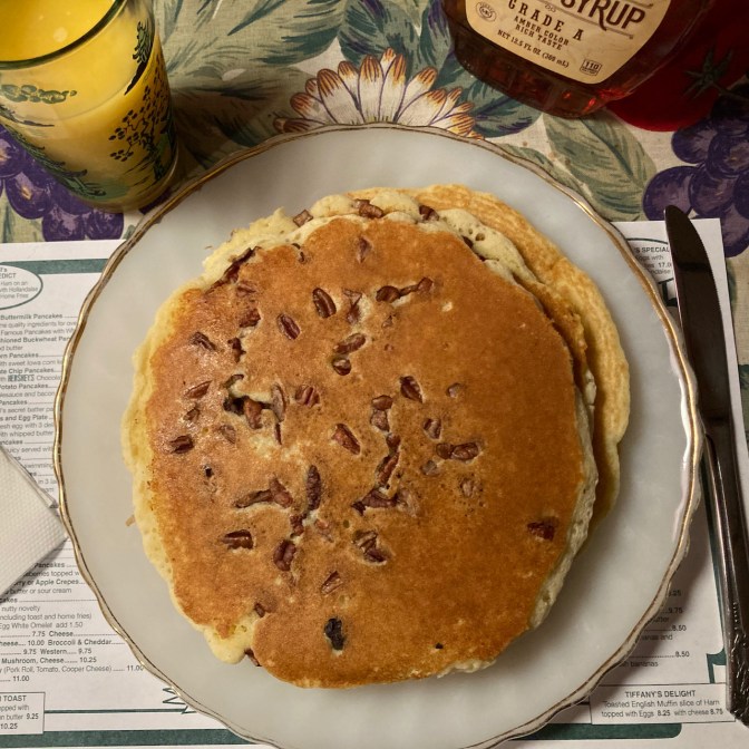 Pecan pancakes on white porcelain plate. 