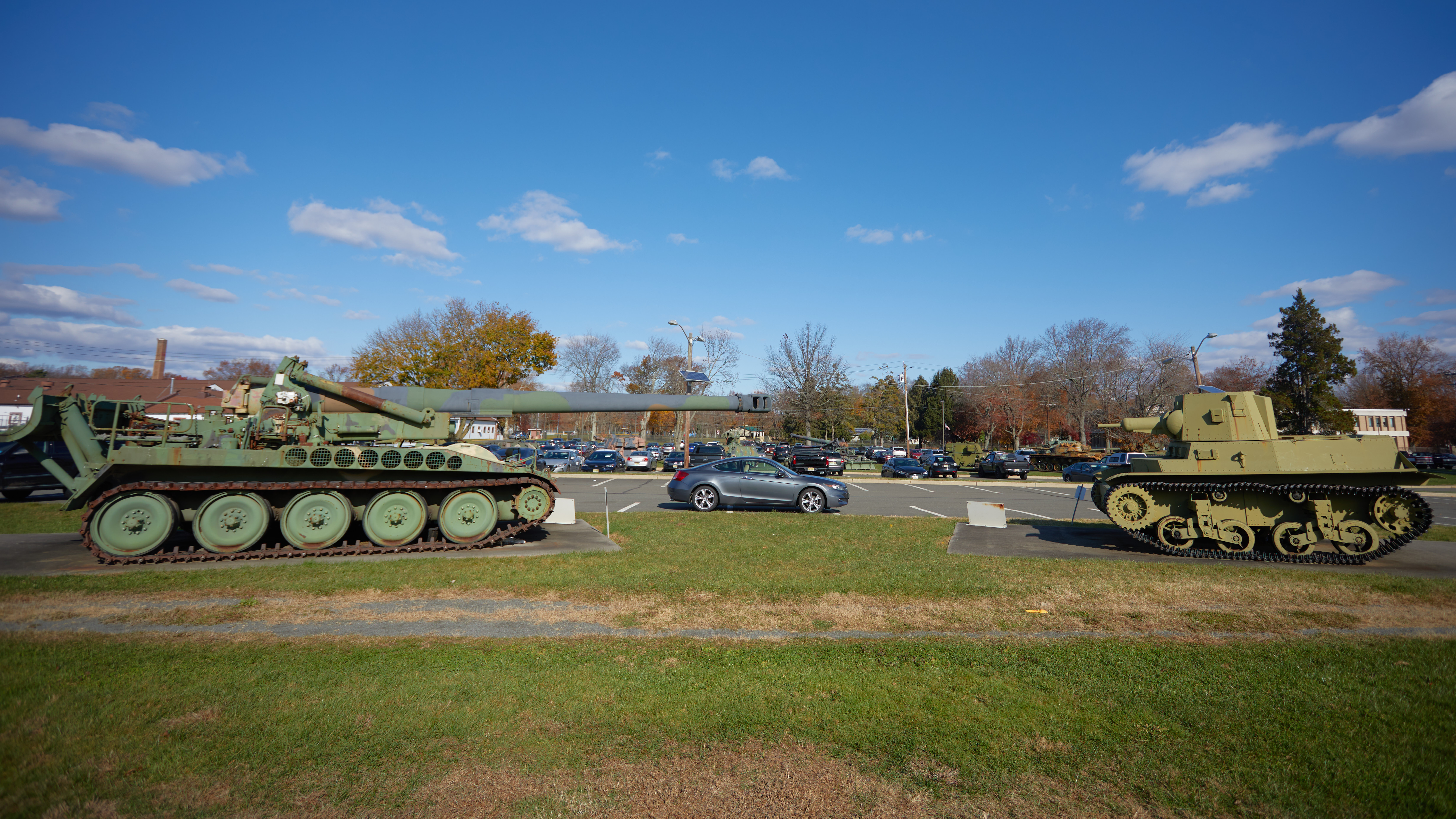 2012 Honda Accord parked between howitzer and tank. 