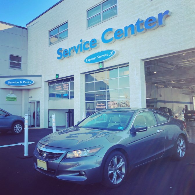 2012 Honda Accord coupe outside of Burns Honda Service Center entrance. 