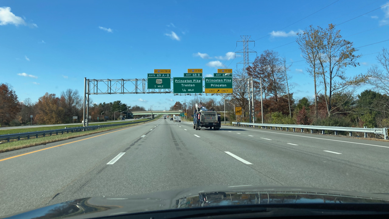 View of I-95 with exit ramp signs in distance. 
