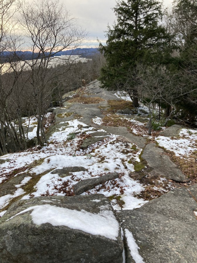 Snow-covered rocks on top of hill. 