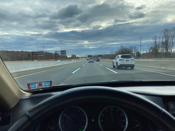 View of New Jersey Turnpike through windshield of car. 