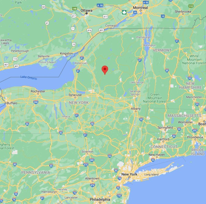 Map of New York state, with red pin in middle of Adirondack State Park. 